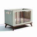 Convertible crib with natural wood legs and mint green finish 120 x 60 x 80cm
